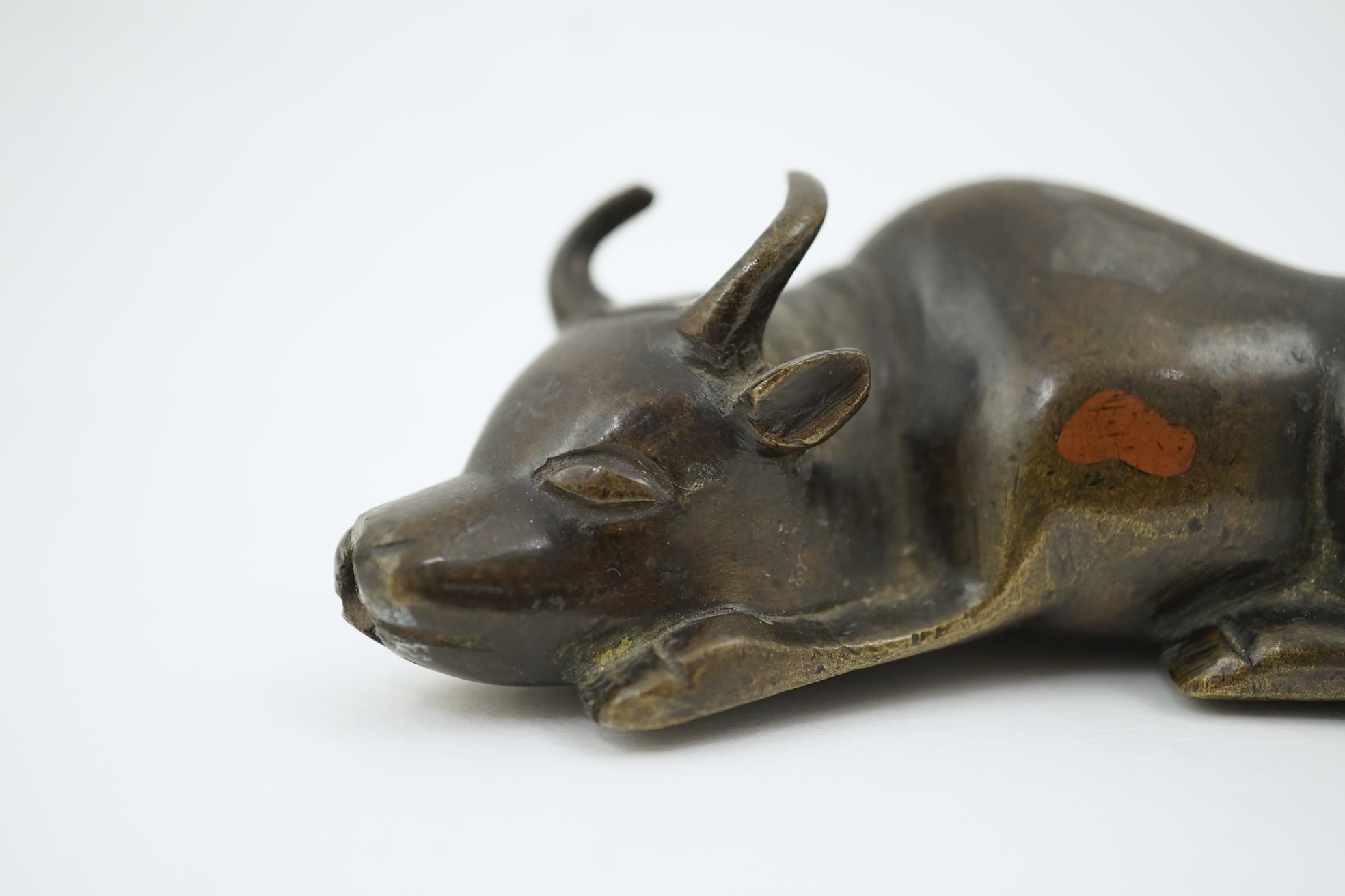 A Chinese bronze and mixed metal buffalo scroll weight, 19th century